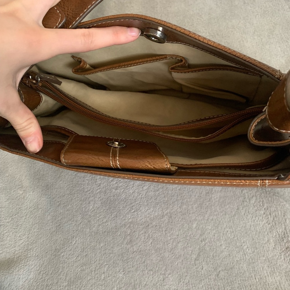 A brown hand bag brand is nine in Co